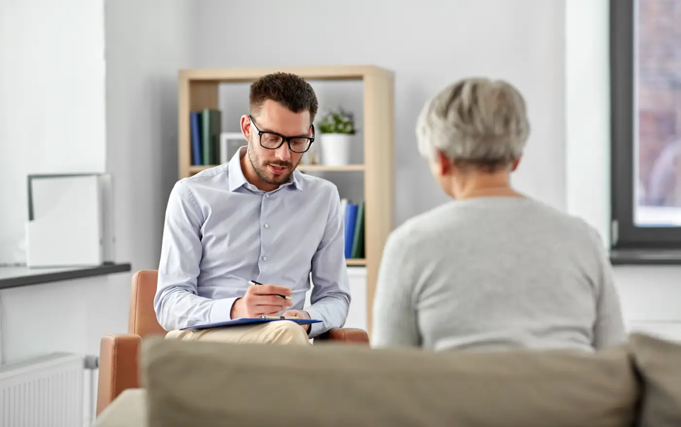 Man counselling an older woman